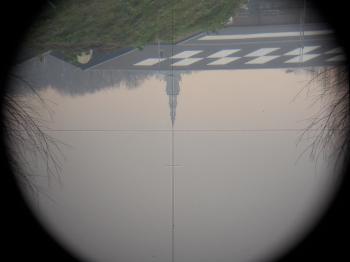 The inverted view through the telescope, showing the etched reticle with stadia hairs.