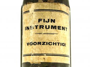 The label of the container reads "Fine instrument, be careful!".