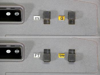 The switches for changing between metres and feet and between gon and degrees.