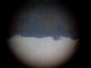 The inverted view through the telescope showing etched vertical stadia hairs.