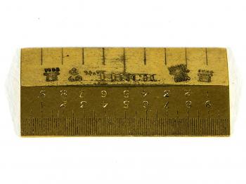 The top side of the Standard Inch with several hallmarks.