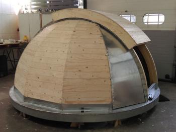 The dome partially cladded in zinc and the main shutter in place to test clearance.
