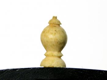 The little ivory knob that would have held a small pencil.